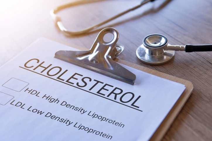 Closeup image of stethoscope and paper clipboard with text CHOLESTROL HDL and LDL .